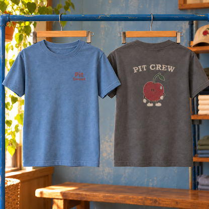 Camp Crew Youth Tee — Blue Jean front and Pepper back in a warm shop display