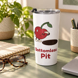 Bottomless Pit tumbler with its clear lid on a green desk beside a notebook