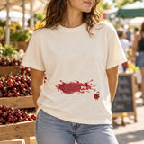 Vintage White cherry-spill tee worn with faded jeans at a cherry market stall